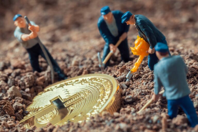 macro miner figurines digging ground uncover big shiny bitcoin scaled