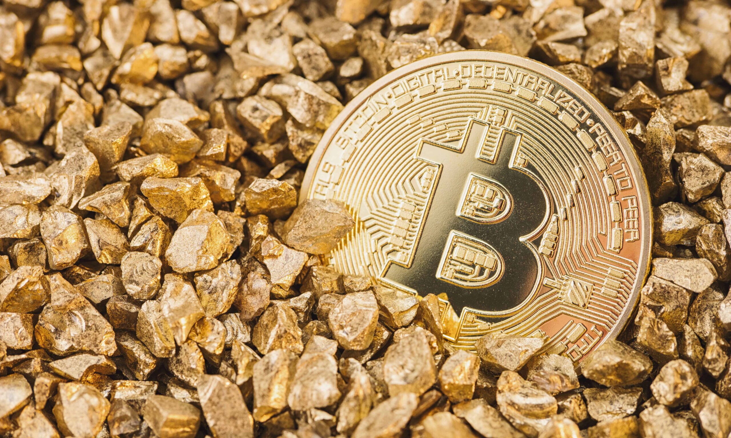 bitcoin virtual cryptocurrency in a heap of gold nuggets bitcoin hype concept image ideal for websites and magazines layouts scaled