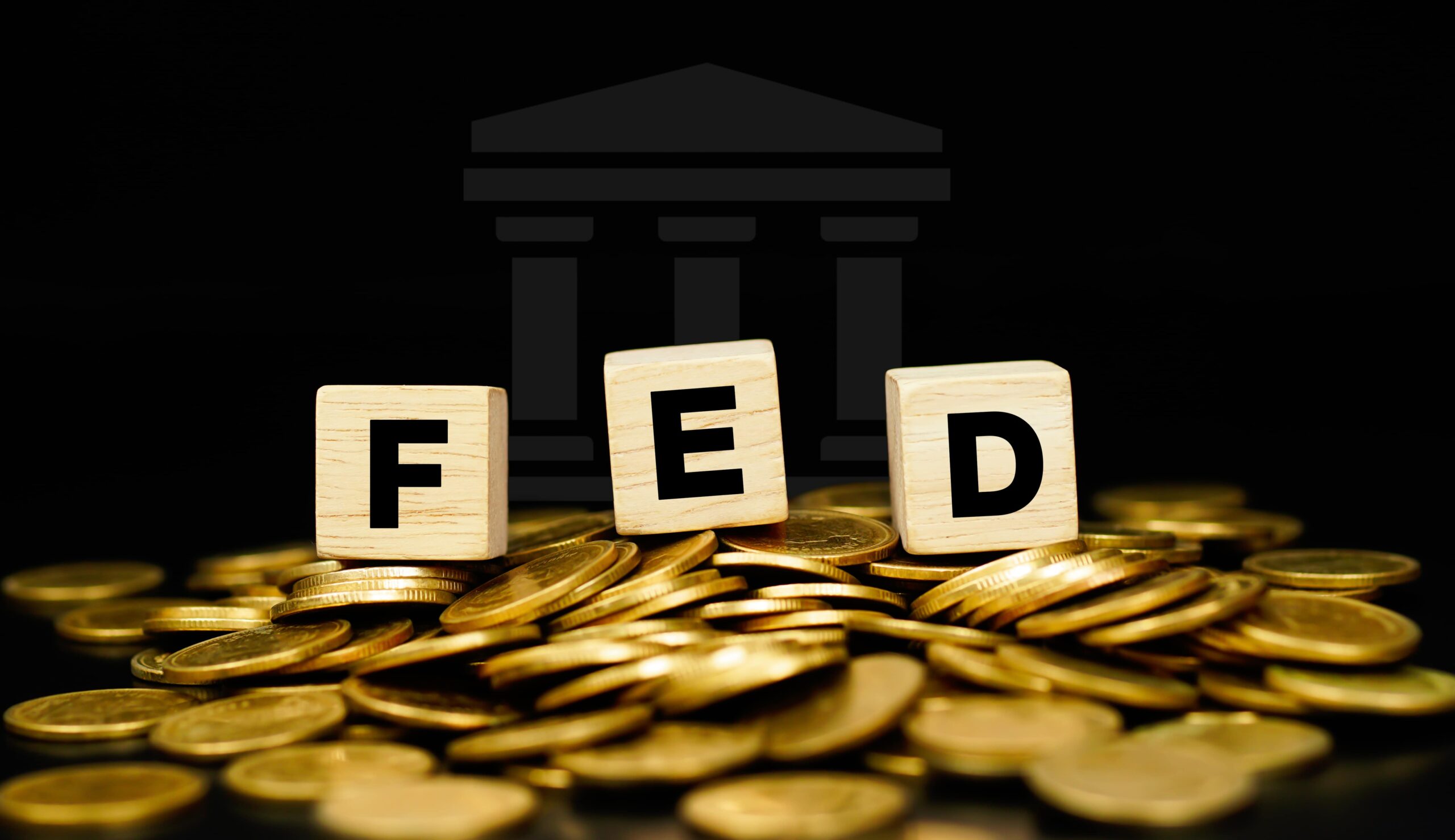 stacks of gold coins with the letters fed on a wooden cube business concept scaled
